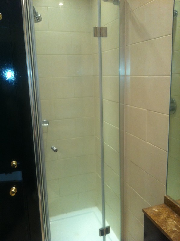 Frameless glass shower enclosure with chrome fittings in Bayswater