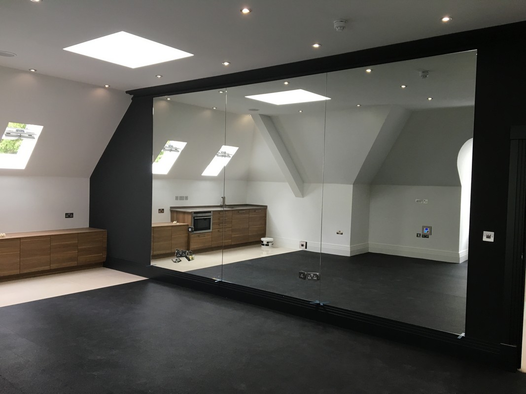 Frameless glass wall dividing loft conversion in Bayswater