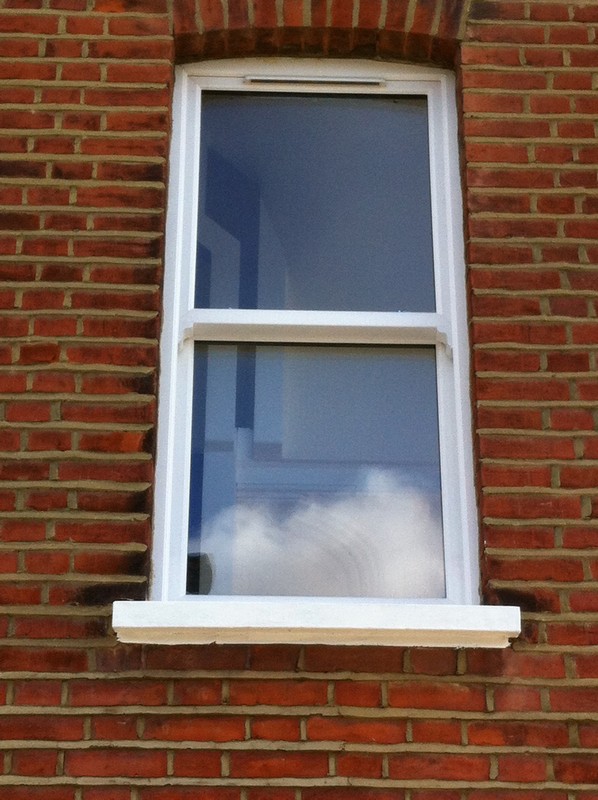 uPVC sash window on Victorian red brick house in Bayswater